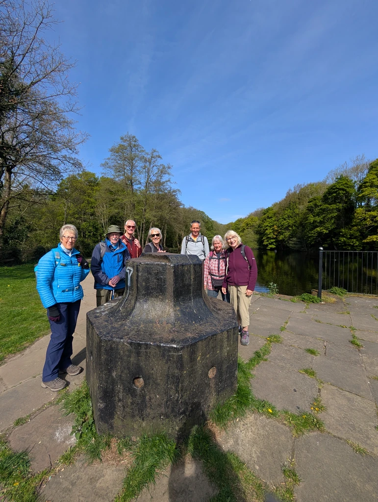 The group pose behind a huge iron capstan
