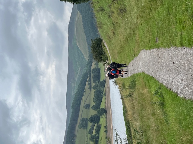A shot of the group in the distance along a zig-zagging gravel path
										not too far from the reservoir edge