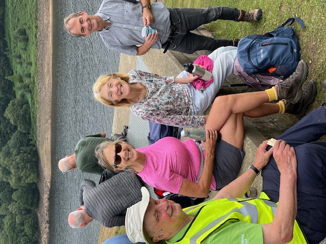 Another photo of smiling group members by the reservoir during the break