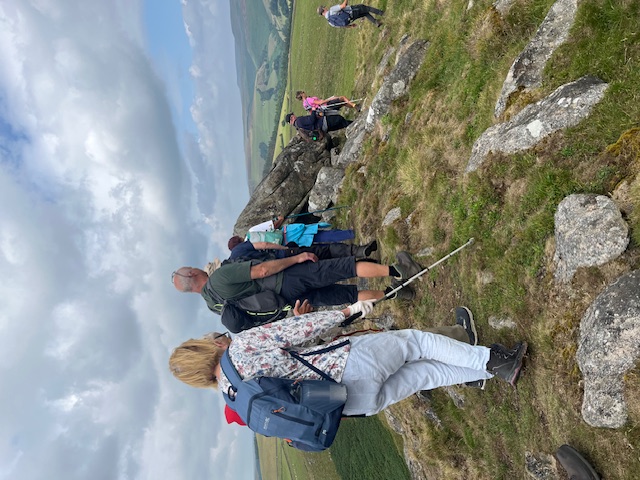 The group are carefully traversing a rocky part of the terrain